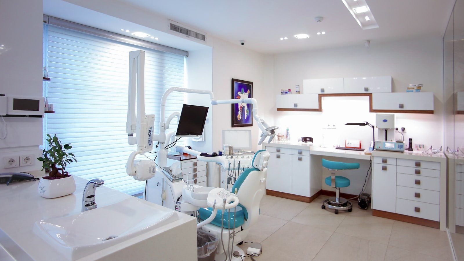 Modern dental treatment room with chair and overhead light