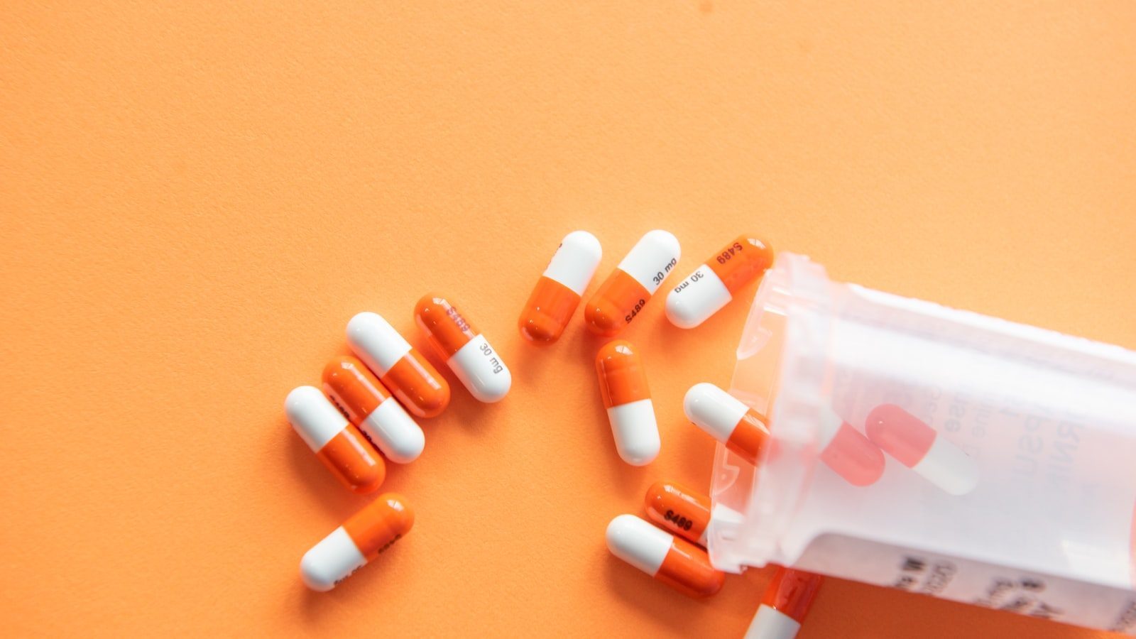 Shelves of medicines behind a community pharmacy dispensing counter