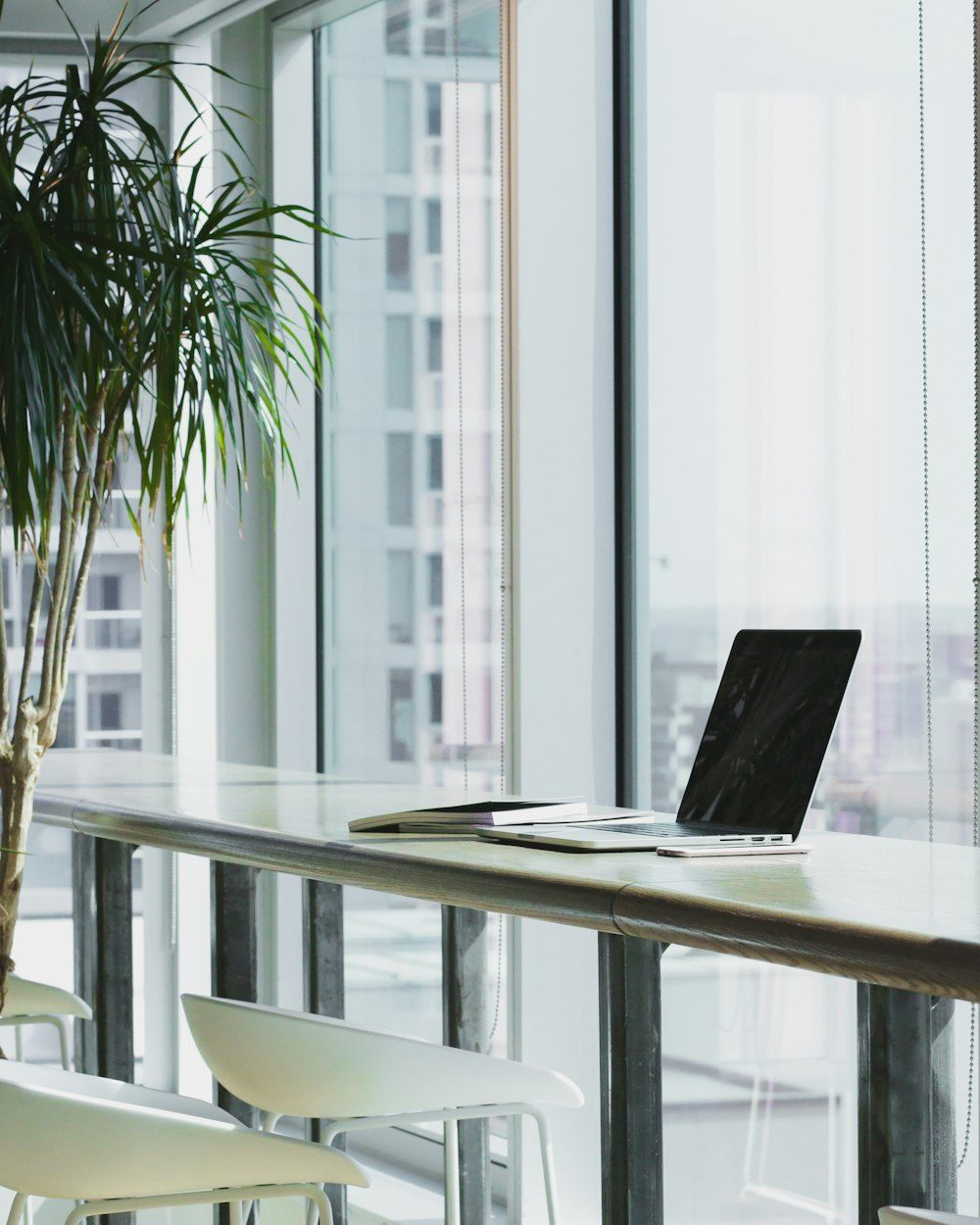 Desk with dual monitors in a busy office